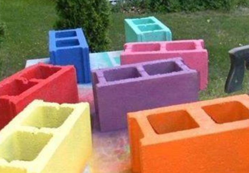 She stacks a colorful row of cinder blocks in the garden. A few steps later? This is BRILLIANT!